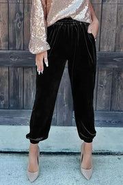 Black velvet jogger pants with relaxed leg silhouette