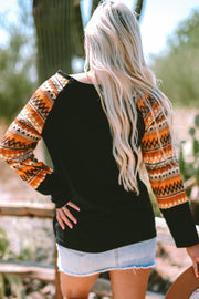 Geo print raglan top showing colorblock patchwork detail