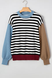 Striped colorblock sweater showing patchwork sleeve detail and relaxed fit