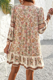 Floral tassel mini dress showing long bracelet sleeves