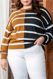 Plus size colorblock striped patchwork loose top in mustard and black, worn by a person in white jeans