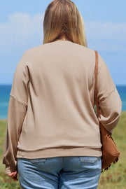 Plus size peace sign sweatshirt showing relaxed shift silhouette and round neckline