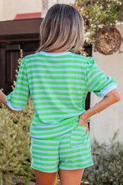 Back view of person wearing green and light blue striped puff sleeve top and matching shorts outdoors