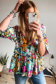 Floral V-neck blouse showing flattering V-neckline and soft ruffle detailing