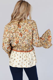 Floral bell sleeve blouse showing dramatic long sleeves