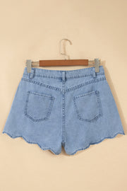 Light blue denim shorts with scalloped hem, shown from back on hanger