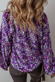 Purple floral blouse showing long bubble sleeves