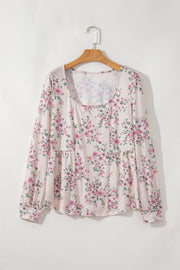 Pink pleated blouse with textured floral print detail