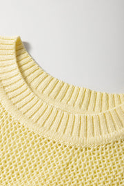 Sleeveless yellow knit vest styled as a layering piece
