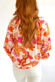 Pearl button keyhole back detail on orange floral blouse