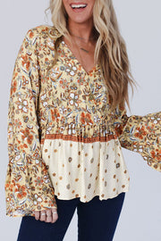 Yellow Printed floral peplum blouse with wrapped V-neck and bell sleeves