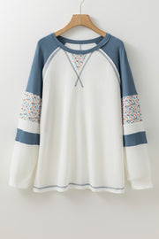 Waffle knit raglan top with exposed seam detailing for structure