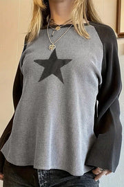Casual crew-neck raglan long sleeve top with bold star patch graphic