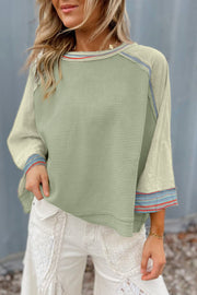 Relaxed shift-cut waffle knit top with raw hem finish