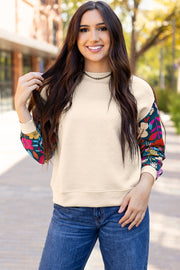 Long sleeve knit top with playful contrast floral detail