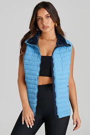 Solid sky blue puffer vest with handy pockets and sheath silhouette