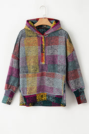Buttoned hooded neckline on oversized plaid hoodie