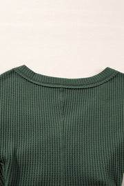Waffle knit V-neck bodysuit styled as a layering top