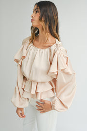 Ruffled peplum hem detail on oatmeal elegant blouse