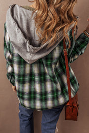 Plaid hooded shacket showing button front and relaxed shift silhouette