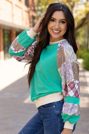 Long sleeve patchwork top styled with denim for a casual weekend look