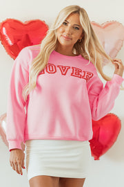 Close-up of hollowed LOVER puff print 3D graphic on pink sweatshirt