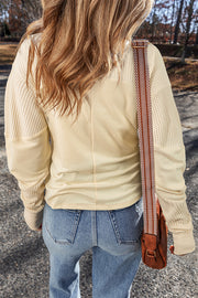 Beige waffle knit top showing patchwork panels and relaxed shift silhouette