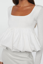 Elegant white U-neck top styled with a graceful bubble hem