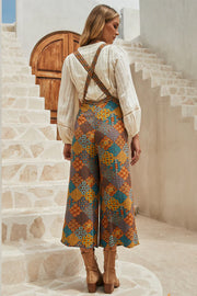 Boho floral jumpsuit featuring a bib front and high-waist wide-leg fit