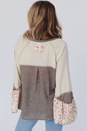 Long sleeve Henley top with half button-up front and round neck