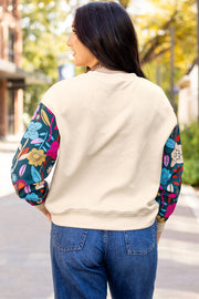 Textured knit top featuring contrast floral long sleeves