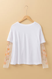 White patchwork top with sheer floral mesh sleeves and soft stretch fabric
