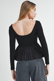 Black peplum top with fitted silhouette and defined waist