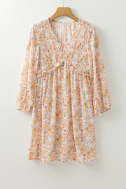 Yellow floral dress with shirred detailing and flowing skirt