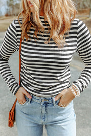 Black textured knit long sleeve tee with high neckline and slim sheath fit