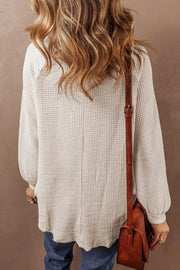 Waffle knit button-front blouse showing raw hem and textured fabric detail