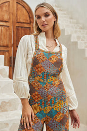 Floral print jumpsuit with crossed adjustable straps and relaxed wide-leg silhouette