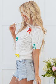 Mock neck sweater with relaxed shift fit and bow accent