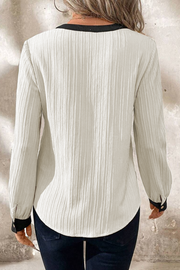Textured colorblock blouse showing relaxed shift silhouette
