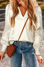 Oatmeal jacquard V-neck bishop sleeve blouse with textured geometric weave