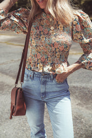 Round neck floral top with ruffled trim detail