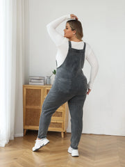 Vintage-inspired denim jumpsuit with defined high waist and solid pattern