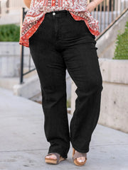 Plus size black denim pants showing zipper fly closure