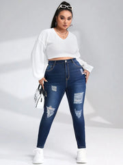 Mid-rise distressed denim pencil pants in faded navy wash