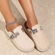Embroidered mules with buckle detail and microfiber midsole