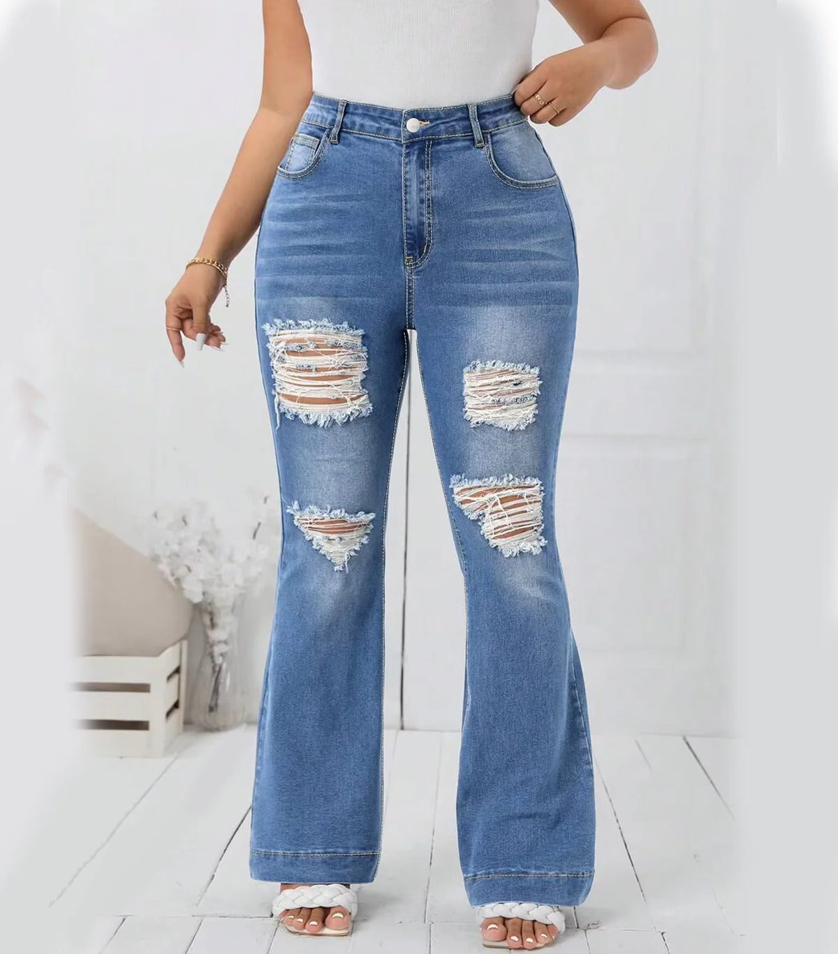 Plus size light blue wide leg flare jeans with ripped details