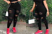 Black pencil-fit ripped jeans styled for everyday wear