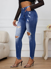 Dark blue skinny jeans with on-trend ripped detailing and mid-rise waist
