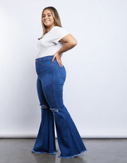 Distressed flared jeans showing ripped knee details