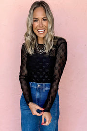 Semi-sheer black bow-patterned top for layering